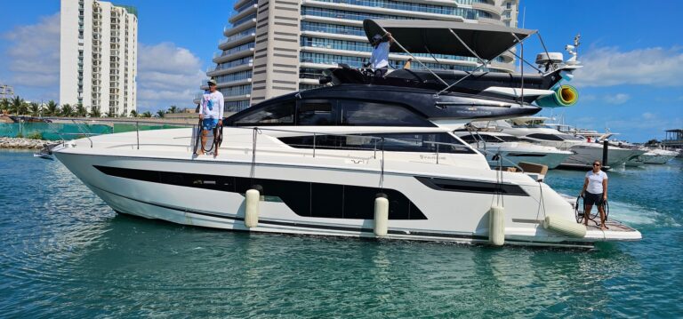 Aerial view of the 53 ft Fairline Squadron luxury yacht charter cruising through turquoise Caribbean waters near Cancun coastline at golden-hour sunset