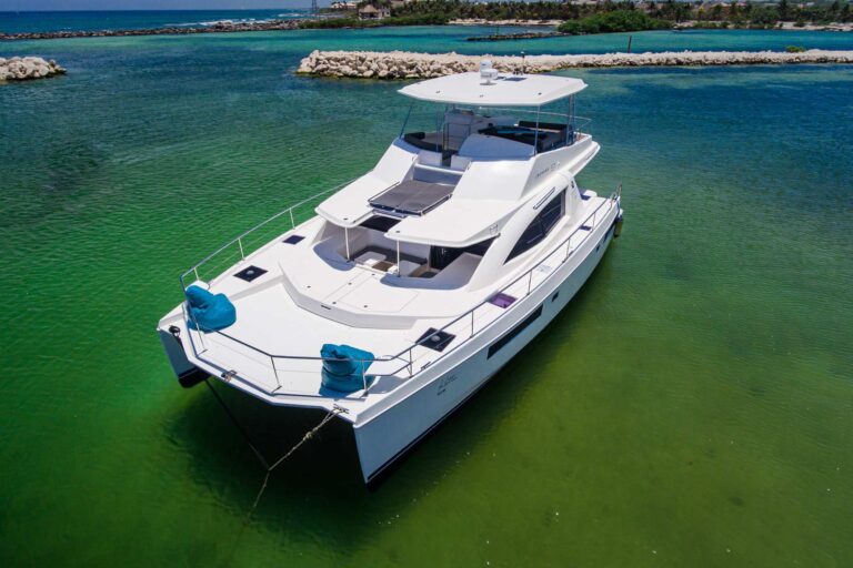 Full side profile of 51 ft Leopard power catamaran rental at Riviera Maya, displaying distinctive two-deck design, flybridge, and brilliant turquoise Caribbean water